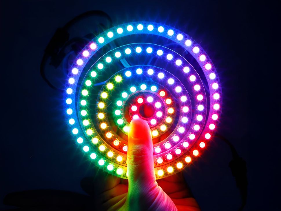 WS2812B 5050 RGB LED Rings in Hand and Illuminated